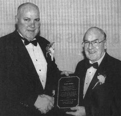 Laurence McGrath, president of the Donegal Football Club of New York presenting a plaque to Frank Molloy