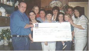 Ronan Molloy (secretary of "Friends of the Handicapped (Ardara branch), South-West Donegal"), Lauren McHugh, Jenny McHugh, Ann McHugh, Suzie McHugh, Sarah McHugh, and Janet Connolly. Back row : Clare Molloy, Karen Doherty, and Pauline McHugh.