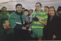 Ardara man and chairman Donegal Co. Board, John McConnell presents Ardara's captain Eamon Doherty with the Democrat Cup