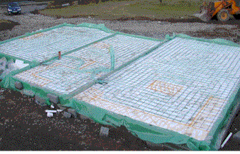 This is a picture of a house at rising wall stage after the pipe has been laid 