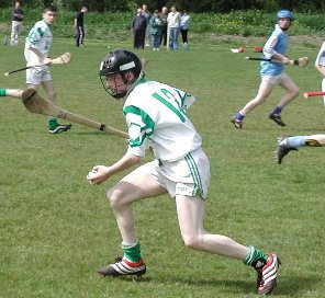 A hurler about to poc the sliotar